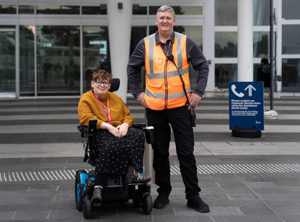 A person in wheelchair outside Adelaide Airport waiting for transport