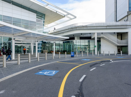 A taxi pulling up to a Accessible pick up space at Adelaide Airport