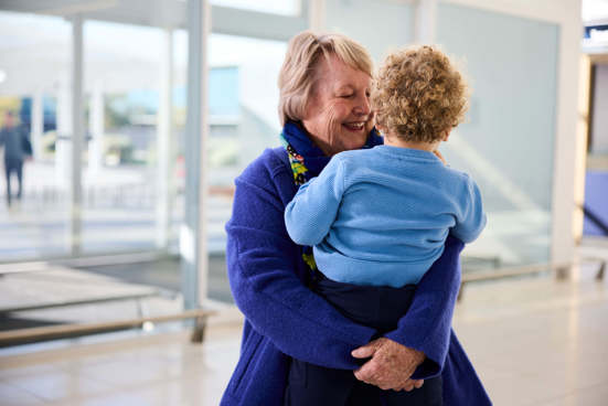 A girl hugs her father in the Adelaide Airport terminal