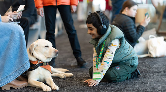 Boy with hidden disability interacting with facility dog
