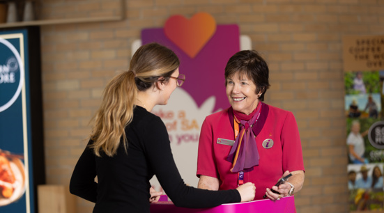 An airport ambassador helps a passenger