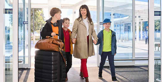 family entering airport terminal