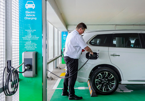 A person charging their electric vehicle at and Adelaide Airport carpark 