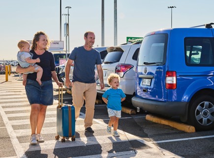 A family walking through a car park