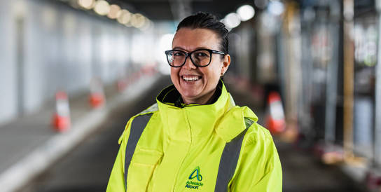 AAL female employee wearing hi vis smiling at camera 