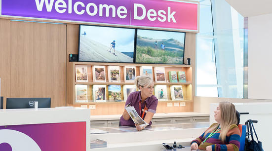 Image of someone walking up to the Help Desk at Adelaide Airport