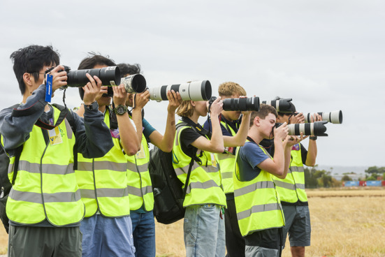 Group of people taking photos with long Lense cameras