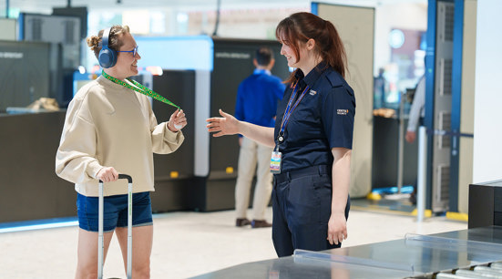 Girls walking through Airport Security with Hidden disability lanyard 