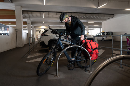 Image of a person locking their bike up at Adelaide Airport