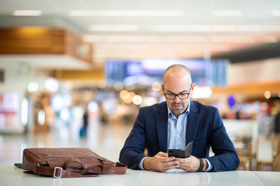 man in suit looking at mobile phone