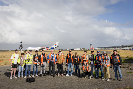 Group of people standing on the runway